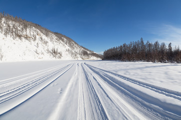 Fototapeta na wymiar winter road on the frozen river bed
