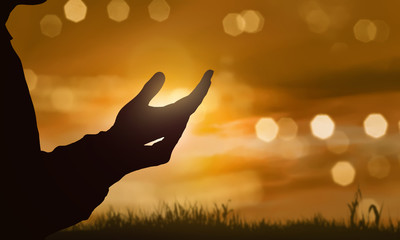 Fototapeta premium Silhouette of human hand with open palm praying to god