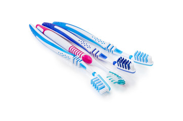 Different toothbrushes on a white matte surface closeup