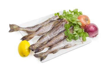 Uncooked carcasses of the Alaska pollock with cilantro, lemon, onion