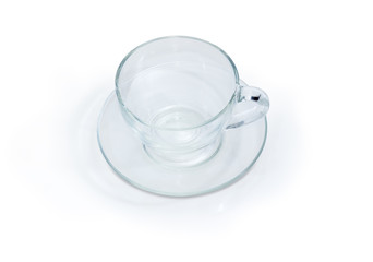 Empty glass cup with handle on glass saucer