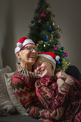 Fototapeta na wymiar Senior mother and adult daughter, christmas reunion