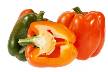 Vegetables of orange and green pepper isolated on white background.