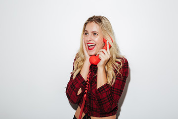 Excited woman standing isolated