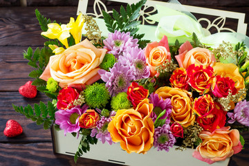 Valentine's background or wedding day. Beautiful bouquet of flowers as a gift on a wooden background.