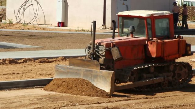 Bulldozer prepares ground for laying a new road
