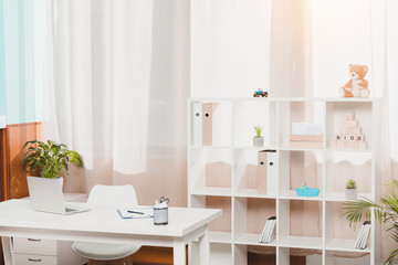 doctors workplace and bookshelf with folders in clinic