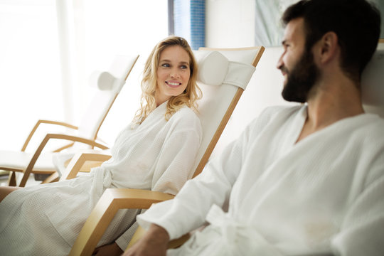 Beautiful woman and handsome man relaxing in spa center