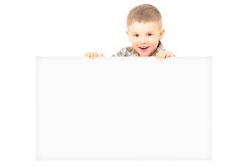 Portrait of a cheerful boy, peeking from behind a banner, isolated on white background