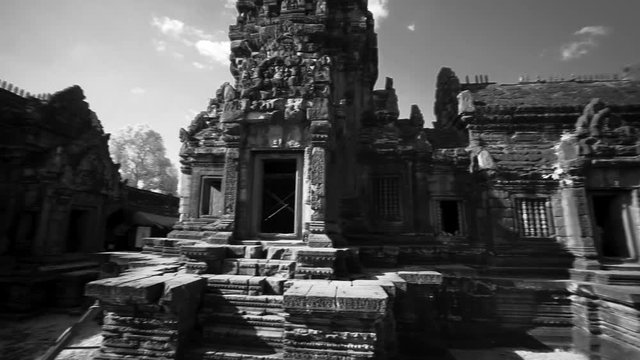 Slow whip pan across the many ruins of Banteay Srei temple in Angkor Wat Archeological Park.
