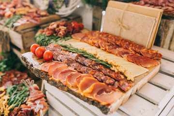 Meat, cheese and nutmeg wedding buffet with various snacks.