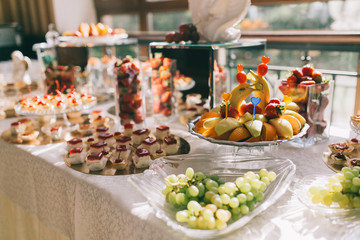 Sweet wedding buffet with different of desserts and fruits.