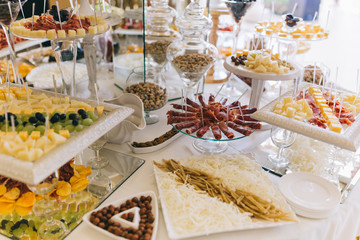 Meat, cheese and nutmeg wedding buffet with various snacks.