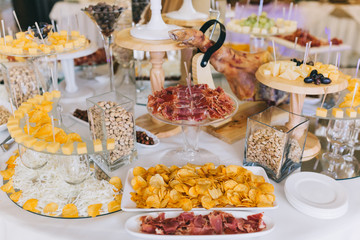 Meat, cheese and nutmeg wedding buffet with various snacks.