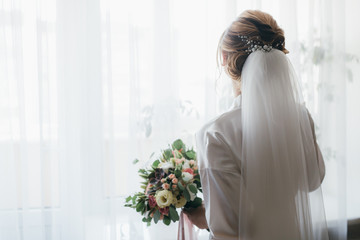 Bride holding beautiful bridal bouquet on the wedding.