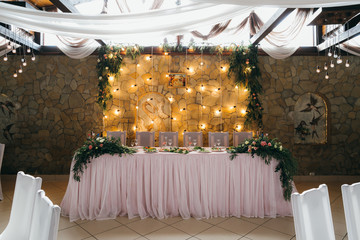 Decorated wedding table with food, drink, appliances and flowers.