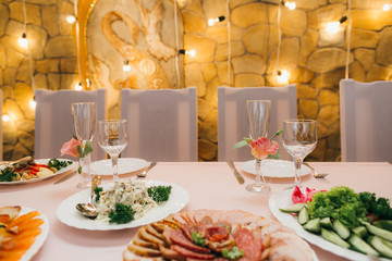 Decorated wedding table with food, drink, appliances and flowers.