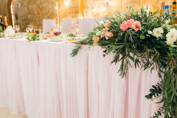 Decorated wedding table with food, drink, appliances and flowers.