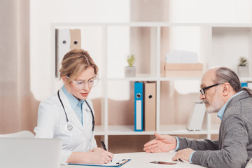 side view of senior patient at the doctors reception in clinic