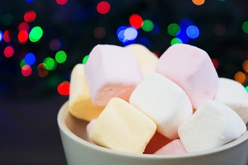 Cup of marshmallows on Christmas background