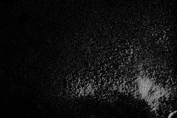 White powder, isolated on black background, top view