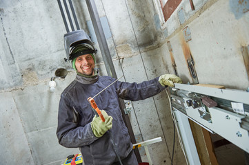 lift worker welder in elevator lift shaft