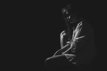 The depression woman sit on the chair on dark background, sad  asian woman silhouette in dark,...