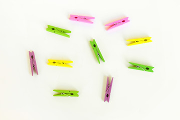 Brown wood clothespin, paper clip on white background