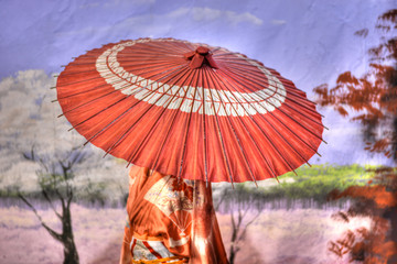 Walking with the umbrella to shelter from the sun