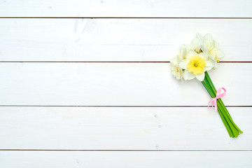 Bouquet of daffodil flowers on white wooden background, copy space. Top view, flat lay. White narcissus. Spring flowers. Greeting card for March 8 (Women's Day), Mother's day. Spring easter background