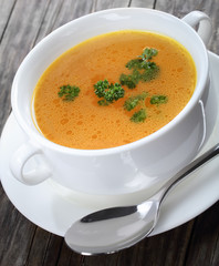 Chicken broth with parsley in a soup cup
