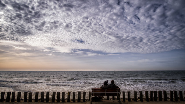 Silhouette of couple at the pier in Pier in Vlissingen, Zeeland, Holland, Netherlands - Powered by Adobe