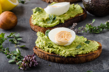 Bio avocado on bread with boiled egg
