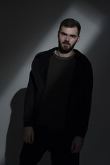 Portrait of an attractive young man dressed in all black