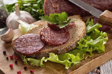salami and bread on a wooden board