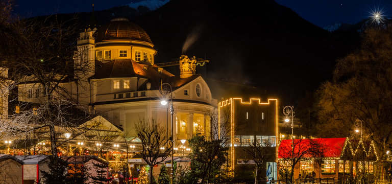 Meran Merano in South Tyrol, Italy, during the Christmas with christmans market by night . Beautiful light and great atmosphere