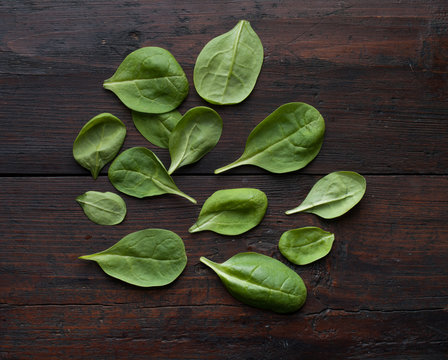 fresh green spinach on vintage wooden texture