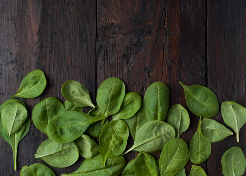 fresh green spinach on vintage wooden texture