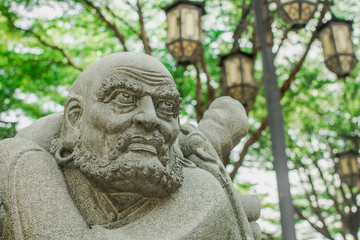 Chinese monk stone statue face on garden