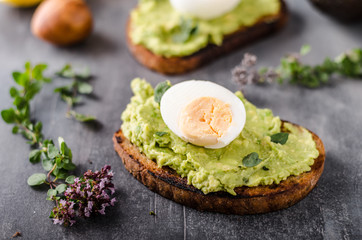 Bio avocado on bread with boiled egg