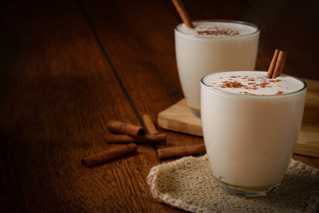 Eggnog houmemade with cinnamon and kakao for Christmas and winter holidays or wooden broun...