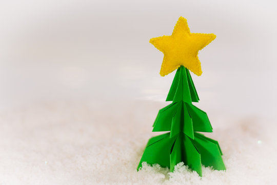 miniature paper pine tree figure with felted star on the top, selective focus