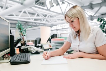 beautiful girl sitting behind a Desk