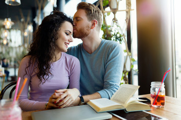 Young happy couple on date in coffee shop