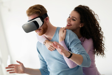 Attractive young couple trying virtual reality headset