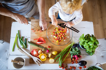 Young father with a toddler boy cooking. - Powered by Adobe