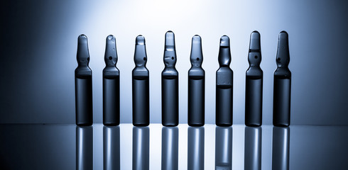 Medical ampules for injection isolated on blue background