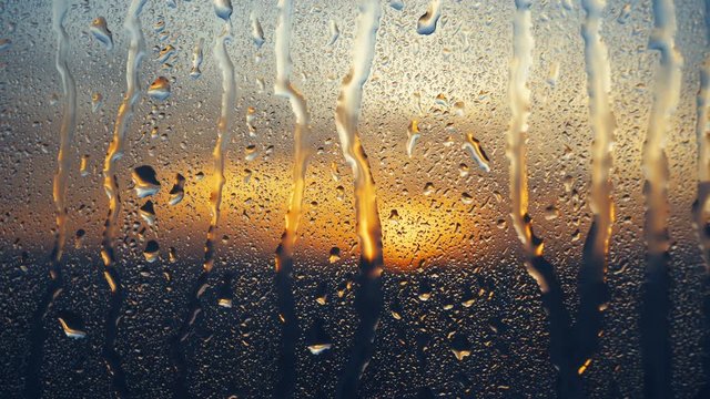 Beautiful sunrise while raining. Watching the sunrise behind the window. 4K