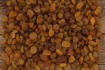 Raisins  on the old wooden table.