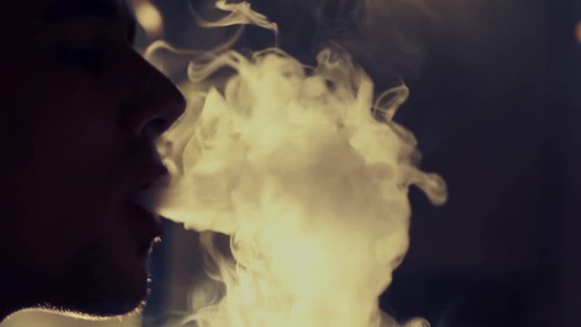 Young man smoking hookah in a bar